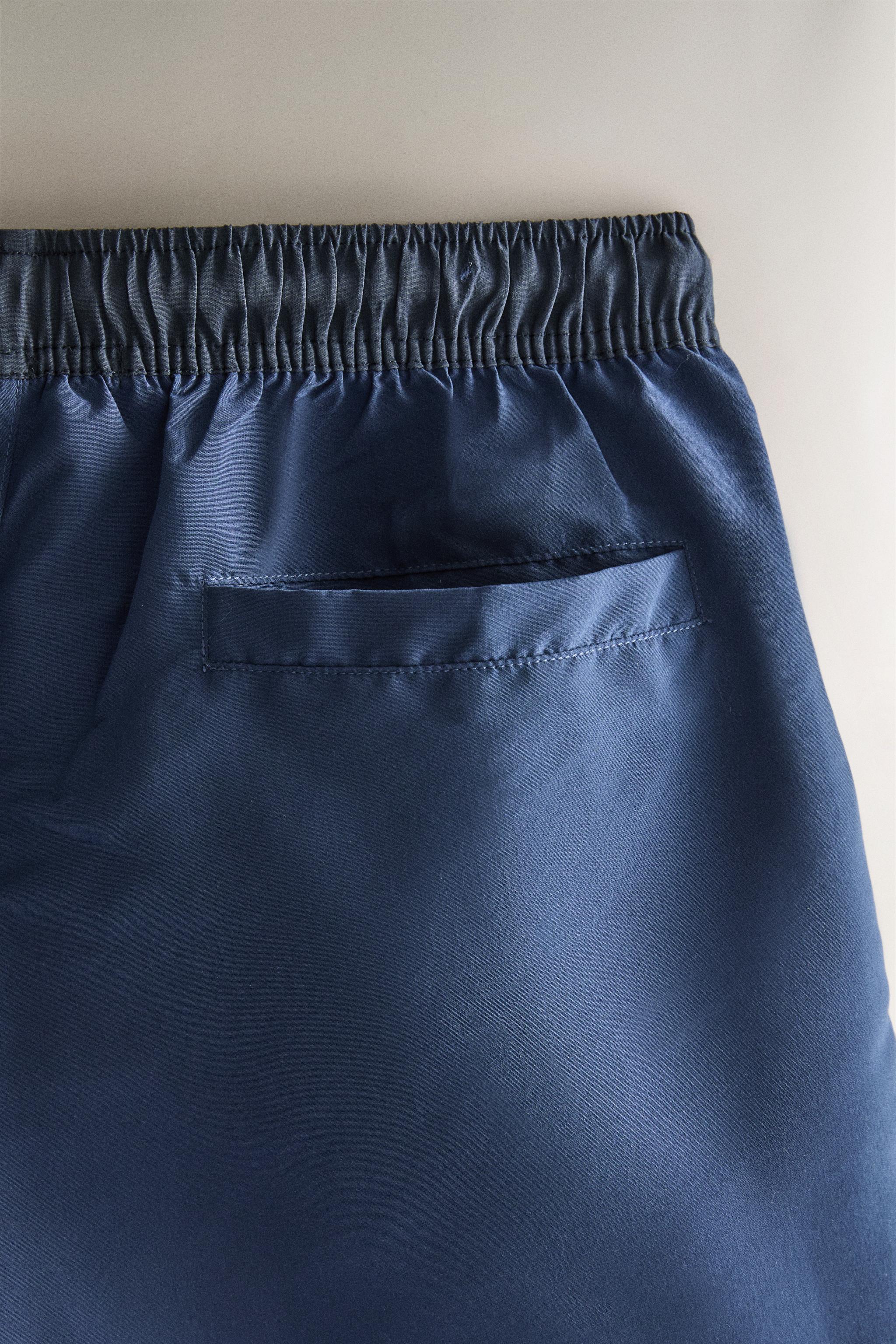 SHORT DE BAIN UNI À CONTRASTE
